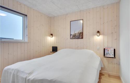 a bedroom with a white bed and a window at Stunning Home In Jægerspris With Sauna in Jægerspris