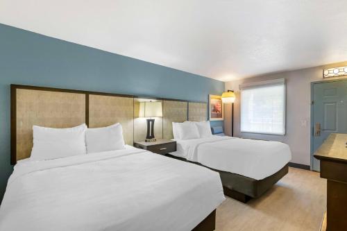 a hotel room with two beds and a window at Best Western Plus St. Simons in Saint Simons Island