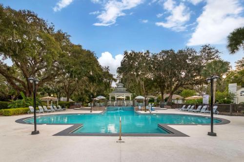 a swimming pool with chairs and a gazebo at Best Western Plus St. Simons in Saint Simons Island