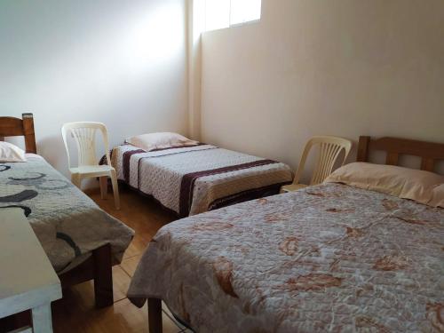 Ένα ή περισσότερα κρεβάτια σε δωμάτιο στο Casa de Campo y Hospedaje Irma