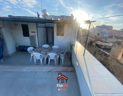 a patio with a table and chairs on a balcony at Casa Bianca bnb,Big Terrace,10 min Airport Beaches in Bitonto