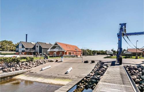 a group of birds sitting on a street next to a river at Apartment Bogense With Sea View V in Bogense