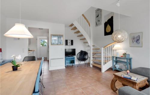 a living room with a table and a staircase at Three-Bedroom Holiday Home In Blavand in Blåvand