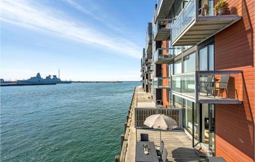 a building with a tent on a dock next to the water at Amazing Apartment In Korsør in Korsør