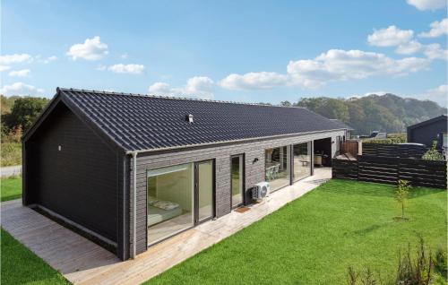 a house with a black roof and a yard at Lovely Home In Haderslev With Wifi in Haderslev