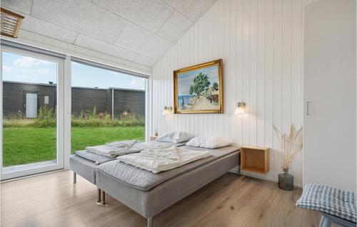 a bed in a room with a large window at Lovely Home In Haderslev With Wifi in Haderslev