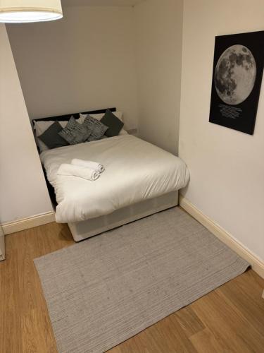 a bed in a corner of a room at Archway Court in London