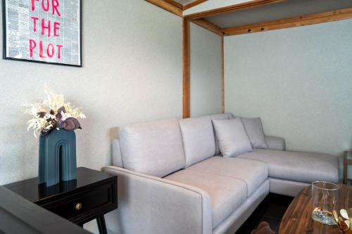 a living room with a white couch and a table at The Jardin in Kami-furano