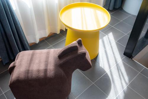 a lamp sitting next to a chair in a room at The Jardin in Kami-furano