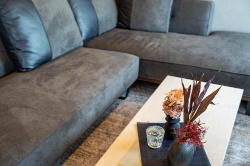a living room with a couch and a coffee table at The Jardin in Kami-furano