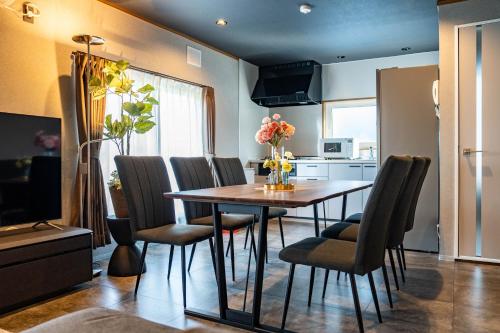 a dining room with a table and chairs at The Jardin in Kami-furano