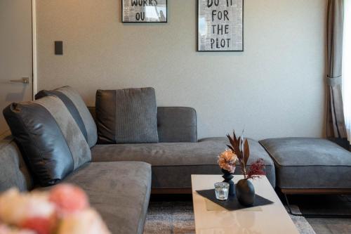 a living room with a couch and a coffee table at The Jardin in Kami-furano