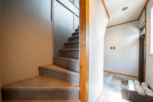 a staircase in a house with concrete steps at The Jardin in Kami-furano