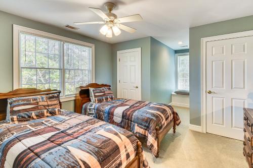 a bedroom with two beds and a ceiling fan at Lakefront Hartwell Retreat with Gas Grill and Deck! in Hartwell