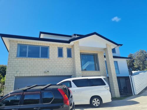 a white van parked in front of a house at Dream House 3 in Auckland