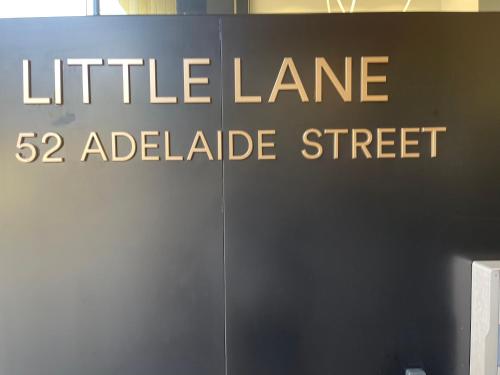 a sign that reads little lane adelaide street at Little Lane Apartments Comfortable, Chic New Apartment in Heart Of Fremantle Features Large balcony & Free car bay in Fremantle