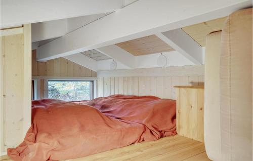 a bedroom with a bed with a blanket on the floor at Holiday Home Knold-Åsen H-617 in Vejby