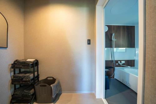 a bathroom with a toilet and a sink and a tub at The Chateau in Yoichi