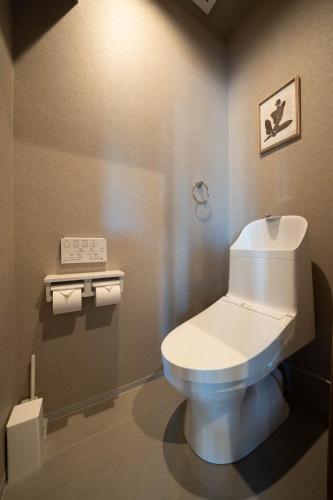 a bathroom with a white toilet in a room at The Chateau in Yoichi