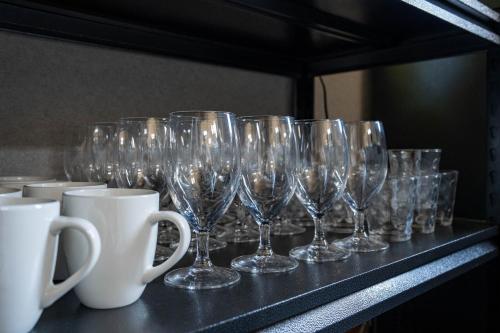 a row of wine glasses sitting on a shelf at The Chateau in Yoichi