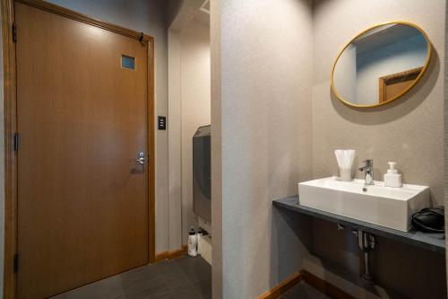 a bathroom with a sink and a mirror at The Chateau in Yoichi