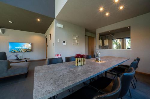 a large kitchen and living room with a large table at The Chateau in Yoichi