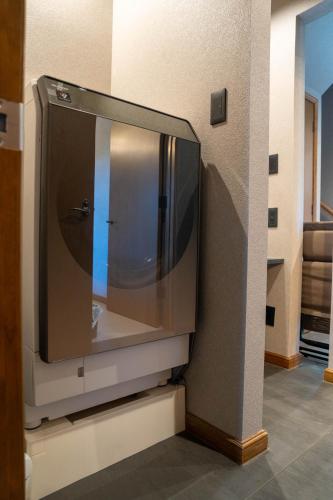 a television sitting on a wall in a room at The Chateau in Yoichi