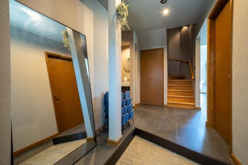 a hallway with blue chairs and stairs in a building at The Chateau in Yoichi