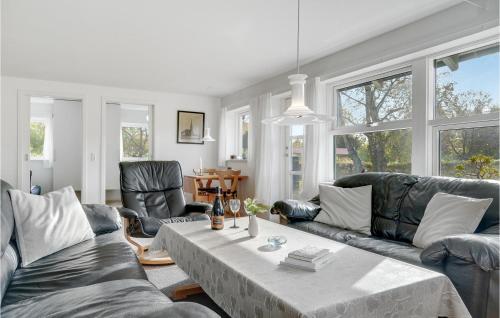 a living room with a couch and a table at Holiday Home Stege 35 in Pollerup Kullegård