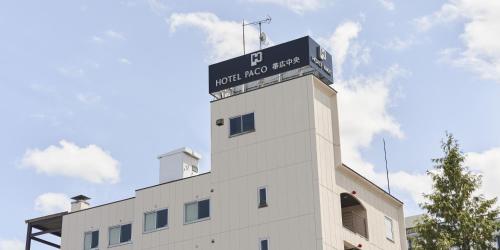 a white building with a sign on top of it at Hotel Paco Obihiro Chuo in Obihiro