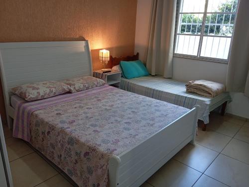 Postel nebo postele na pokoji v ubytování Hotel Pousada das Rosas