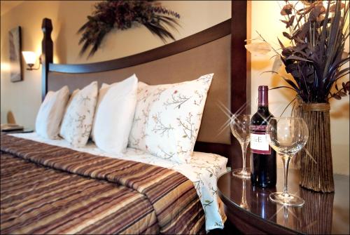 
a bed with two pillows and a wine glass at Hotel Citadelle in Quebec City
