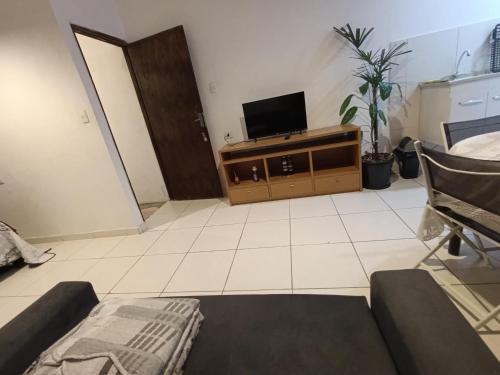 a living room with a flat screen tv on a cabinet at Casa na histórica - Santana de Parnaíba SP in Santana de Parnaíba