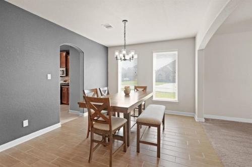 a dining room with a table and chairs at Gated Community 2-story Home2 in Rosenberg