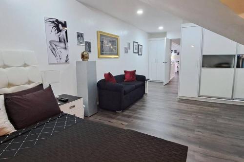 a living room with a couch and a chair at Kandi Paramount Executive 1BR 140sqm and 400mbps in Angeles