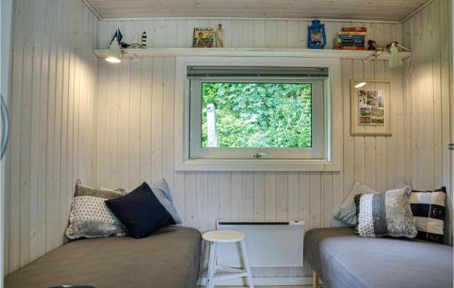 a small room with two beds and a window at Holiday Home Ledgårdsvej N-614 in Hornbæk