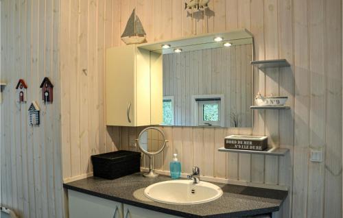 a bathroom with a sink and a mirror at Holiday Home Ledgårdsvej N-614 in Hornbæk