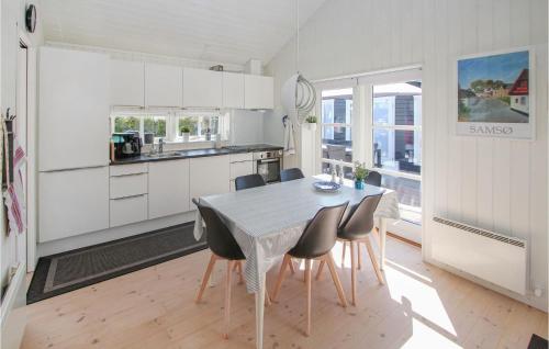 a kitchen and dining room with a table and chairs at Gorgeous Home In Samsø With Kitchen in Onsbjerg