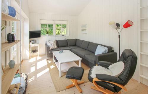 a living room with a couch and a table at Gorgeous Home In Samsø With Kitchen in Onsbjerg