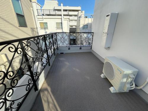 a balcony of a building with a bench on it at COMMA HOUSE Shinjuku 303 in Tokyo