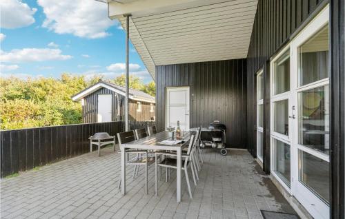 a patio with a table and chairs on it at Awesome Home In Tarm With Sauna in Tarm