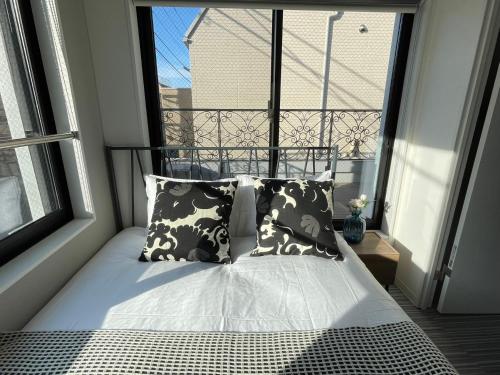 a bed in a room with a large window at COMMA HOUSE Shinjuku 303 in Tokyo