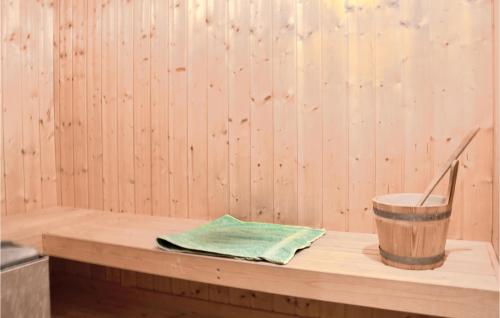 a wooden tub with a bucket and a napkin at Four-Bedroom Holiday Home In Dronningmolle in Dronningmølle