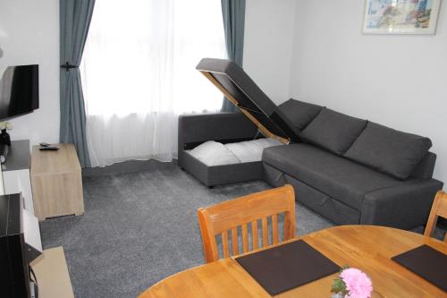 a living room with a couch and a table at U-DIN HOMES in Weymouth