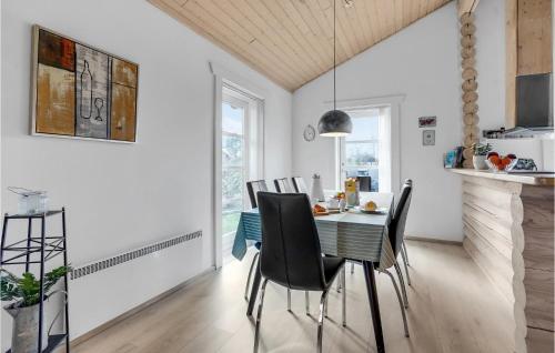 a kitchen and dining room with a table and chairs at Holiday Home Marielyst Strandpark Væggerløse Ii in Marielyst