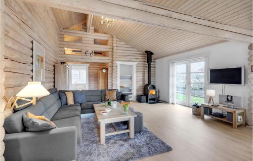 a living room with a couch and a table at Holiday Home Marielyst Strandpark Væggerløse Ii in Marielyst
