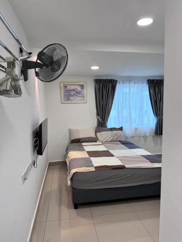 a bedroom with a bed and a fan at Famosa 2 Stay at Ong Kim Wee in Melaka