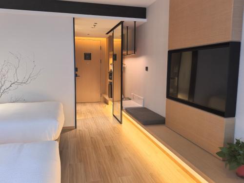a bedroom with a large flat screen tv on the wall at Fairfield by Marriott Hangzhou Qiantang in Hangzhou