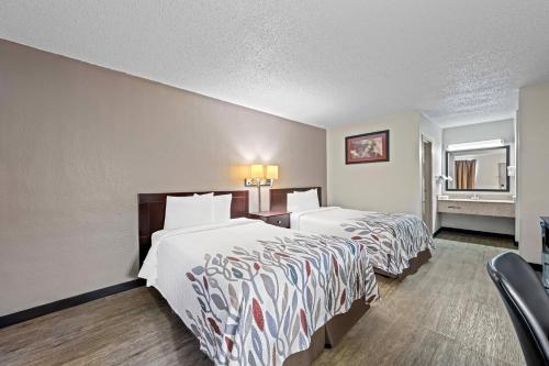 a hotel room with two beds and a window at Red Roof Inn Abingdon in Abingdon