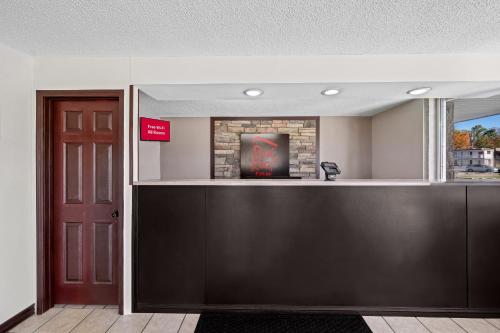 a bar in a room with a fireplace at Red Roof Inn Abingdon in Abingdon